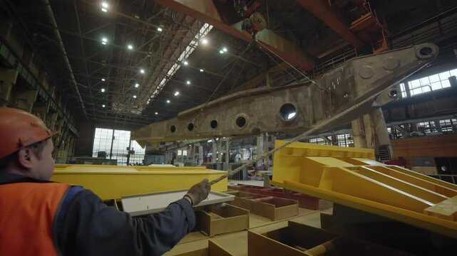 Industrial Shipbuilding A Worker Skillfully Operating a Crane in a Busy Dockyard Setting. Stock Clip