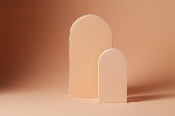 Two wooden arch on a beige background, element for design with copy space for text or image