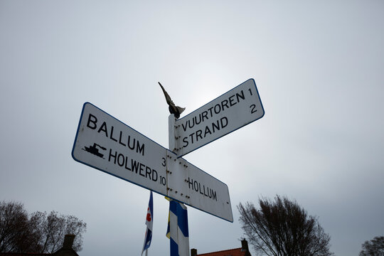 Road signpost indicates directions to Ballum, Holwerd, and Vuurtoren 1/Strand.  Possible Dutch village locations.
