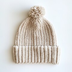 A cozy knitted beanie with a ribbed texture and a pom-pom on top on a white background 