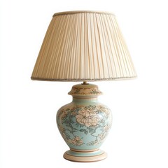 A vintage table lamp with a decorative ceramic base and soft fabric shade on a white background 