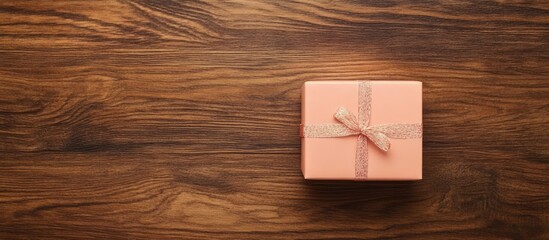 Christmas gift box with decorations on wooden table creating a festive atmosphere and leaving space for personalized text or messages.