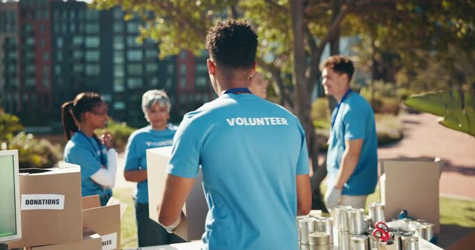 People, volunteering and outdoor with boxes for help, donation drive and community care. NGO team, packaging and public service in city for social responsibility, distribution or supplies for poverty