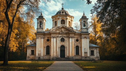 Fototapeta premium 17th century classical church surrounded by autumn foliage highlighting architectural beauty and historical significance