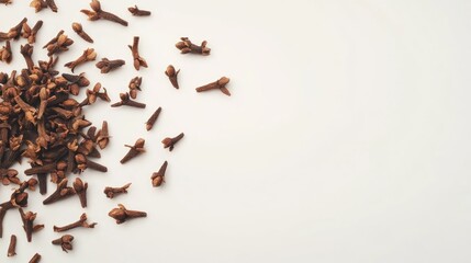 Dried Cloves Spilled on White Surface Culinary Spice for Flavoring and Aromatic Uses