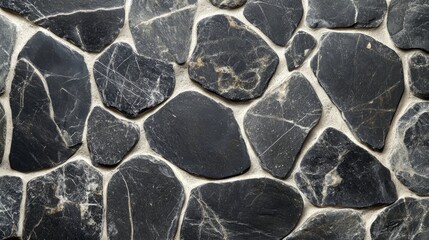 Textured black stone wall background for architectural, interior design, or natural stone decoration purposes in modern environments.