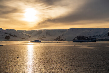 Icebergs and Glaciers align the coast of the Antarctic peninsula, and its many islands. Image taken during the golden hour after sunrise in the Gerlache strait