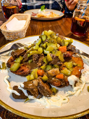 Potato pancake with beef sauce.
