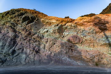 Detail of the colors in the Natural Monument Azulejos de Veneguera or Rainbow Rocks in Mogan, Gran...
