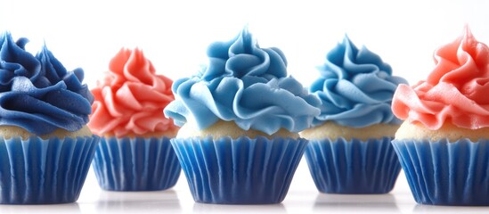 Patriotic themed cupcakes with vibrant blue and red frosting arranged on a white background for festive celebration or event themes