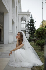 Obraz premium An Elegant Bride Standing Outside and Posing Gracefully in Her Stunning Wedding Attire
