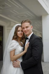 An Elegant Wedding Couple Embracing in the midst of Romantic Bliss and Affectionate Joy © pavelvozmischev