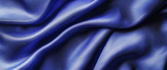 Obraz premium Smooth blue satin fabric with gentle folds and curves.
