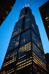 Illuminated skyscraper at night, city skyline.