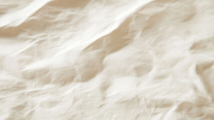 A close-up of crumpled fabric in soft, neutral tones.