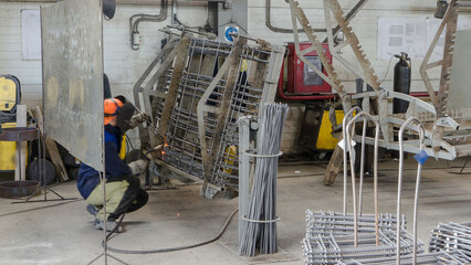 welder working with electrode at semi-automatic arc welding in manufacture production plant timelapse