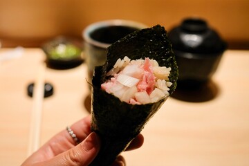 Maki sushi roll with onion and negitoro (minced raw tuna belly) with brown rice, served as part of an omakase lunch at Manten Sushi Marunouchi near Tokyo Station and the Imperial Palace — Chiyoda