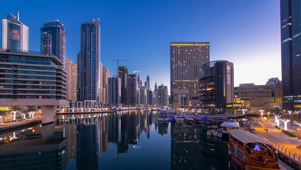 Naklejka premium Dubai Marina towers and canal in Dubai night to day timelapse