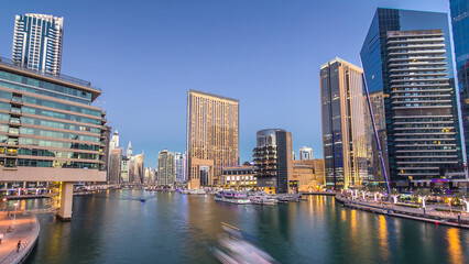 Fototapeta premium Dubai Marina towers and canal in Dubai day to night timelapse