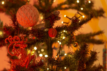 A beautifully detailed closeup view of a festive Christmas tree adorned with colorful decorations and twinkling lights that shine brightly