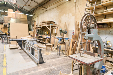 Woodworking tools and materials in a bustling lumberyard workshop