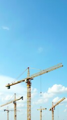 Tower Cranes Against a Bright Blue Sky With Cloudy Background Scene