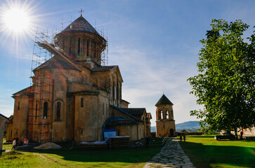 Historic Church or Monastery with Dome and Scaffolding Against Blue Sky