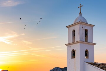 Solitary church bell tower against a pastel sky at sunset with birds in flight, symbolizing peace and spirituality.