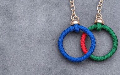 Colorful Thread Rings on Chain Gray Background Crafts DIY