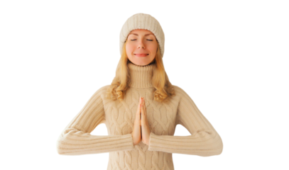 Portrait relaxed young woman meditates in yoga position closed eyes winter sweater, hat isolated