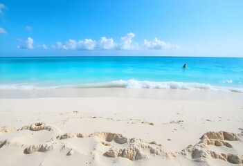 A tropical beach with white sand and clear turquoise water under a blue sky with wispy clouds
