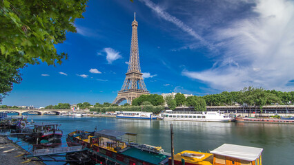 Naklejka premium The Eiffel tower timelapse hyperlapse from waterfront at the river Seine in Paris