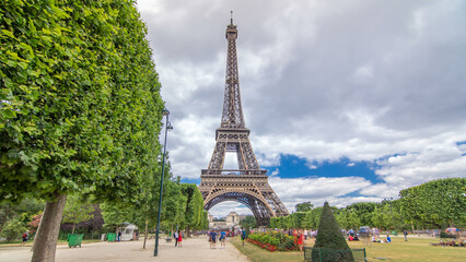 Champ de Mars and the Eiffel Tower timelapse hyperlapse in a sunny summer day. Paris, France