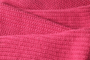 Bright saturated pink background knitted with pattern for design. Textured wool. Abstract backdrop. 