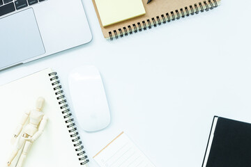 Top view copy space, desk office with laptop, blank notepad, coffee cup and pen on table, Work from home.