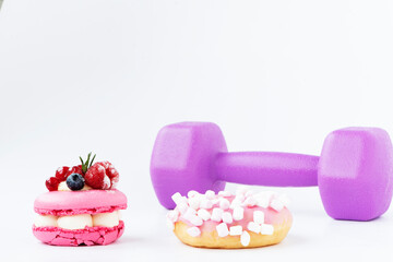 Sweet on dumbbell background. Concept of healthy lifestyle, sport and proper nutrition.