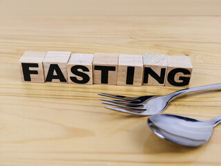 The word Fasting in wooden blocks. Fasting concept illustration