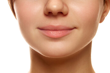 Cropped image of female face, nose, lips and chin against white studio background. Face building massage, perfect chin line. Concept of natural beauty, skin care, cosmetics and cosmetology