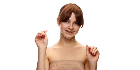 Young beautiful woman holding dental floss and smiling confidently, promoting oral hygiene and...