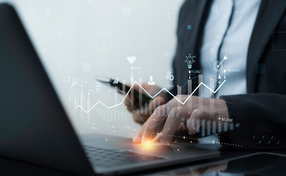 Professional working on a laptop with data visualization graphs and analytics. The dynamic display of performance charts highlights decision-making and strategy in business environments