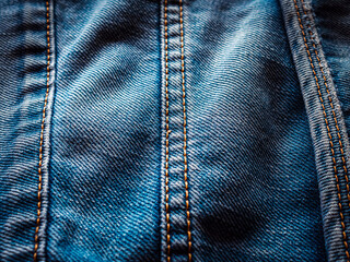 Close up of seam of blue denim texture background, jean fashion style, macro