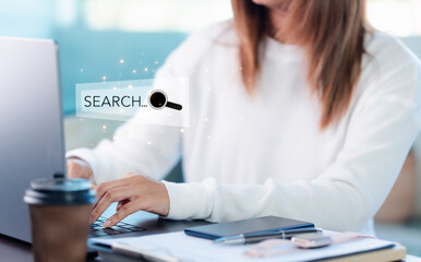 businessman,typing on keyboard,with search box on virtual screen, hologram, searching for information on internet,online reference, deep research of information from all over the world,search engine.