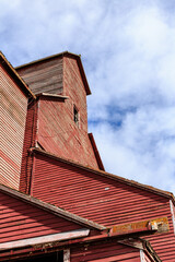 A red building with a red roof and a window
