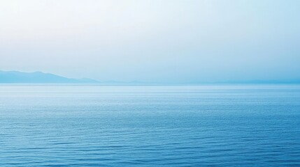 Obraz premium Calm Blue Sea with Soft Horizon and Gentle Waves at Dusk