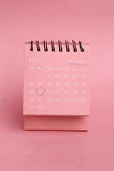 calendar with mark February 14 on pink background