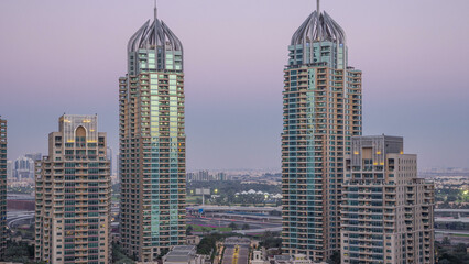 Dubai Marina skyscrapers aerial day to night timelapse, port with luxury yachts and marina promenade