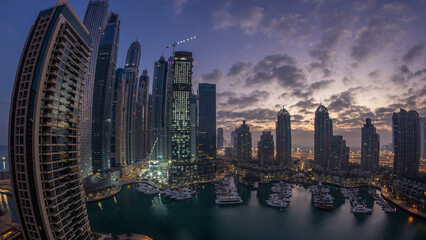 Obraz premium Aerial view of modern skyscrapers night to day timelapse before sunrise in Dubai Marina in Dubai, UAE.
