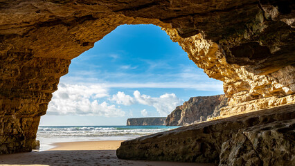 Breathtaking Coastal Cave at Algarve: Sunlight Illuminating the Azure Waves and Golden Sand, Capturing the Tranquil Beauty and Rugged Charm of Portugal's Scenic Coastlin