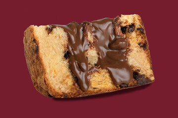 SLICE OF BRIGADEIRO PANETTONE, PANETTONE WITH CHOCOLATE CREAM ON A RED BACKGROUND