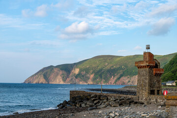 Harbour and beaches of Lynmouth,UK  with iconic Rhenish Tower with sea and rocky coastline in Lynmouth Bay in background
